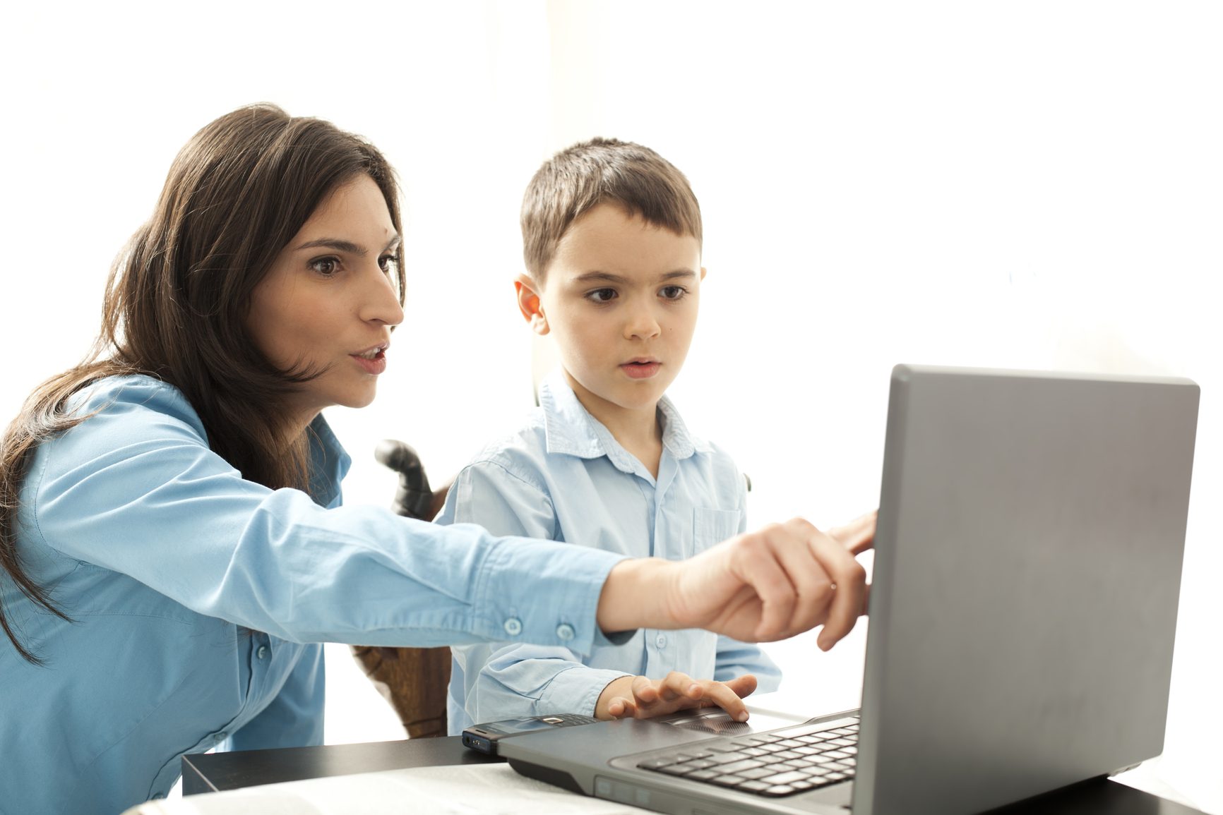 boy leaning to use computer